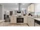 Kitchen with stainless steel oven, range hood, countertops, and tiled floors at 1618 Cooper Lake Se Rd, Smyrna, GA 30082