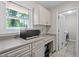 Convenient laundry area with storage cabinets, countertops and a laundry sink at 1618 Cooper Lake Se Rd, Smyrna, GA 30082