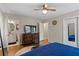 A bright main bedroom features hardwood floors, ceiling fan, and an ensuite bathroom at 1618 Cooper Lake Se Rd, Smyrna, GA 30082
