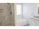 Bathroom with tiled shower, soaking tub, granite countertops, and a window at 1910 Charleston Oak Cir, Lawrenceville, GA 30043