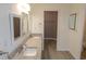 Bathroom featuring double sinks, granite countertops, and modern lighting at 1910 Charleston Oak Cir, Lawrenceville, GA 30043