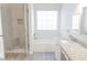 Bathroom featuring a tiled shower, soaking tub, and granite countertops at 1910 Charleston Oak Cir, Lawrenceville, GA 30043
