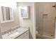 Tastefully designed bathroom featuring granite countertops and tiled stand up shower at 1910 Charleston Oak Cir, Lawrenceville, GA 30043