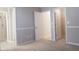 Neutral bedroom featuring carpeting and a walk-in closet with an attached bathroom at 1910 Charleston Oak Cir, Lawrenceville, GA 30043