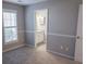 Cozy bedroom with a window, door and adjoining bathroom with granite countertops at 1910 Charleston Oak Cir, Lawrenceville, GA 30043