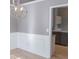 Dining room featuring wainscotting and modern lighting at 1910 Charleston Oak Cir, Lawrenceville, GA 30043