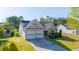 Beautiful exterior view of a tan home with an attached two-car garage and green front lawn at 1910 Charleston Oak Cir, Lawrenceville, GA 30043