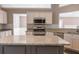 Bright kitchen featuring granite countertops, stainless steel appliances, and white cabinetry at 1910 Charleston Oak Cir, Lawrenceville, GA 30043
