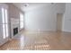 Bright and airy living room featuring hardwood floors, a fireplace, and large windows at 1910 Charleston Oak Cir, Lawrenceville, GA 30043