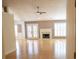 Bright living room with hardwood floors, fireplace, and French doors leading to a sunroom at 1910 Charleston Oak Cir, Lawrenceville, GA 30043