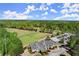 Aerial view of the golf course with clubhouse and parking area, showcasing the community amenities at 404 Prague Way, Hampton, GA 30228