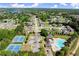 Tennis courts, a pool, and green spaces are among community features shown in this aerial view at 404 Prague Way, Hampton, GA 30228