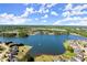 Expansive aerial view of a lakeside neighborhood with lush greenery and well-manicured lawns at 404 Prague Way, Hampton, GA 30228