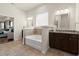 Bright bathroom boasts granite counters, double sinks, soaking tub, and ample space at 404 Prague Way, Hampton, GA 30228