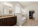 Elegant primary bathroom showcases granite counters, double sinks, soaking tub, and walk-in closet at 404 Prague Way, Hampton, GA 30228