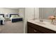 Bathroom vanity features a modern sink and faucet with the bedroom in the background at 404 Prague Way, Hampton, GA 30228