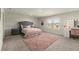 Spacious bedroom with neutral tones, a large window, and comfortable furniture at 404 Prague Way, Hampton, GA 30228