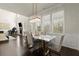 Dining area open to living room offers natural light, stylish decor, and comfortable seating at 404 Prague Way, Hampton, GA 30228