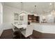 Elegant dining area with modern chandelier, marble table, and seamless access to kitchen at 404 Prague Way, Hampton, GA 30228