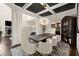 Sophisticated dining room with modern chairs, a decorative chandelier, and a view into the living area at 404 Prague Way, Hampton, GA 30228