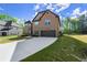 Brick home with well-maintained lawn, long driveway, and attached garage at 404 Prague Way, Hampton, GA 30228