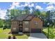 Attractive brick house with well-maintained landscaping and a paved driveway leading to an attached garage at 404 Prague Way, Hampton, GA 30228