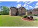 Charming brick home with lush landscaping, and a two-car garage at 404 Prague Way, Hampton, GA 30228