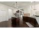 Spacious kitchen boasts stainless appliances, dark cabinetry, granite countertops, and center island at 404 Prague Way, Hampton, GA 30228