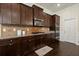 Gourmet kitchen showcases dark cabinetry, stainless appliances, granite countertops and tile backsplash at 404 Prague Way, Hampton, GA 30228
