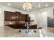 Well-equipped kitchen with granite countertops, stainless steel sink, and dark wood cabinets at 404 Prague Way, Hampton, GA 30228