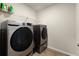 Practical laundry room equipped with new washer and dryer units and plenty of storage at 404 Prague Way, Hampton, GA 30228