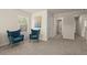 Comfortable sitting area with plush armchairs, lots of natural light, and neutral walls at 404 Prague Way, Hampton, GA 30228