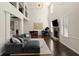 Spacious living room with piano, fireplace, soaring ceilings, and gray sectional sofa at 404 Prague Way, Hampton, GA 30228