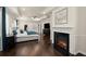 Expansive primary bedroom features tray ceilings, fireplace, hardwood floors, and ensuite bathroom at 404 Prague Way, Hampton, GA 30228