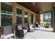Covered patio features comfortable seating and brick columns at 404 Prague Way, Hampton, GA 30228
