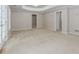 A spacious basement with neutral walls and soft carpet, featuring multiple entryways for convenience and flexibility at 4106 Creekview Ridge Ne Dr, Buford, GA 30518
