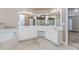 Bright bathroom featuring tub, shower, and vanity at 4106 Creekview Ridge Ne Dr, Buford, GA 30518