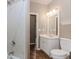 Bathroom features tile shower, commode, and vanity at 4106 Creekview Ridge Ne Dr, Buford, GA 30518