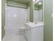 Well-lit bathroom with white tiled shower-tub, sink and green walls at 4106 Creekview Ridge Ne Dr, Buford, GA 30518