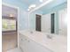 A well-lit bathroom with a double vanity, neutral walls, and large mirror, creating a bright and functional space at 4106 Creekview Ridge Ne Dr, Buford, GA 30518