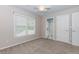A cozy bedroom featuring neutral walls, soft carpet, and a ceiling fan, offering a serene and comfortable space at 4106 Creekview Ridge Ne Dr, Buford, GA 30518