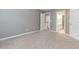 A bedroom with soft carpet and neutral walls, featuring doors to the bathroom and hallway, enhancing accessibility and convenience at 4106 Creekview Ridge Ne Dr, Buford, GA 30518