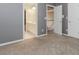 A bedroom with soft carpet and neutral walls, featuring doors to the bathroom and hallway, enhancing accessibility and convenience at 4106 Creekview Ridge Ne Dr, Buford, GA 30518