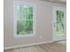 Bright bedroom featuring a window and a door with pane windows and neutral walls at 4106 Creekview Ridge Ne Dr, Buford, GA 30518