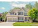 Charming two-story home with a well-manicured lawn, attached two car garage, and mature trees at 4106 Creekview Ridge Ne Dr, Buford, GA 30518