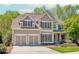 Charming two-story home with a well-manicured lawn, attached two car garage, and mature trees at 4106 Creekview Ridge Ne Dr, Buford, GA 30518