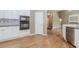 Bright, open kitchen with hardwood floors, white cabinets, stainless steel appliances, and granite countertops at 4106 Creekview Ridge Ne Dr, Buford, GA 30518