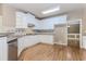 A bright kitchen with stainless steel appliances, wood flooring, and neutral tile backsplash at 4106 Creekview Ridge Ne Dr, Buford, GA 30518