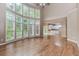 Open-concept living room connecting to a kitchen, featuring abundant natural light from large windows at 4106 Creekview Ridge Ne Dr, Buford, GA 30518