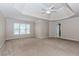 Spacious main bedroom with tray ceiling and carpet floors at 4106 Creekview Ridge Ne Dr, Buford, GA 30518